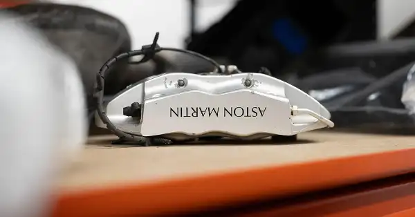 Genuine Aston Martin silver brake caliper on a shelf in the Eurospares warehouse.
