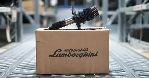 Lamborghini rear driveshaft flange on genuine parts box in Eurospares warehouse.