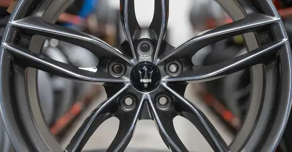 Maserati GranTurismo alloy wheel with trident center cap in Eurospares warehouse.